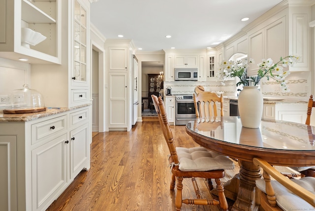 129 Brookmere Dr, Fairfield, CT 06824 - dining room with light wood finished floors, recessed lighting, and crown molding