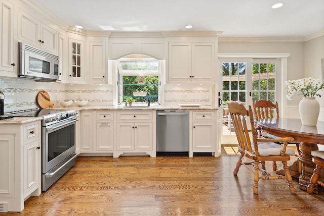 129 Brookmere Dr, Fairfield, CT 06824 - kitchen featuring stainless steel appliances, recessed lighting, decorative backsplash, light stone countertops, and light wood-style flooring