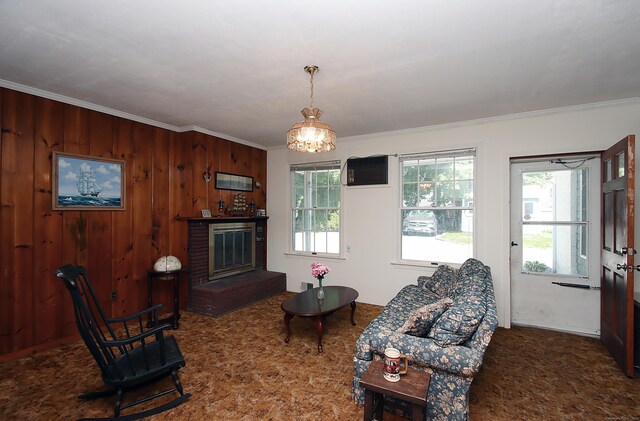 171 Main St, East Lyme, CT 06357 - living room featuring ornamental molding, a wall mounted air conditioner, a chandelier, and wooden walls
