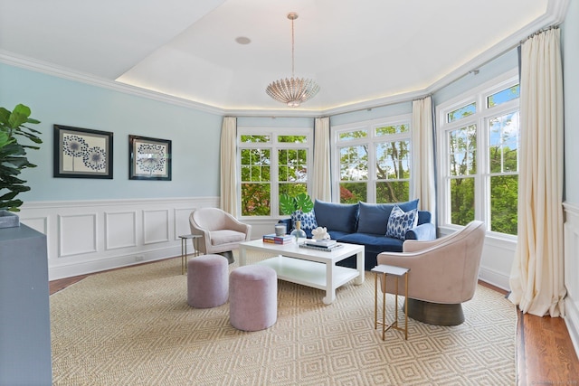 13 Witch Ln, Norwalk, CT 06853 - living room featuring wood finished floors, a tray ceiling, crown molding, wainscoting, and a chandelier