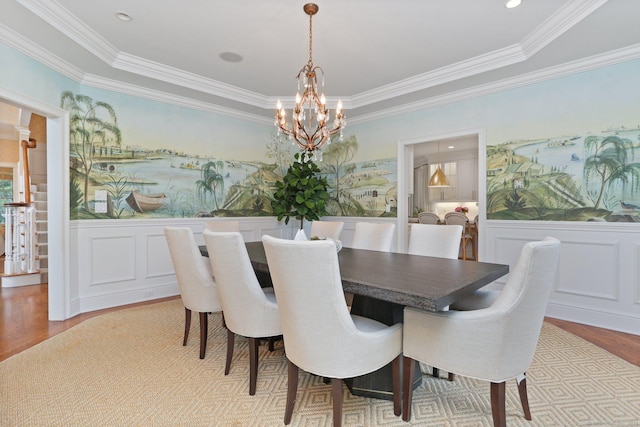 13 Witch Ln, Norwalk, CT 06853 - dining space with a chandelier, wood finished floors, wainscoting, ornamental molding, and a decorative wall