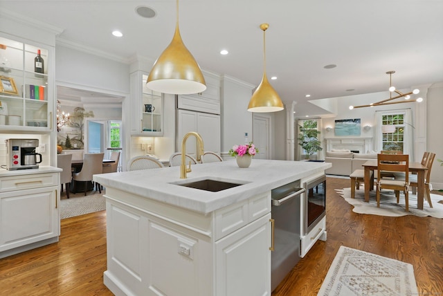 13 Witch Ln, Norwalk, CT 06853 - kitchen with a sink, ornamental molding, a chandelier, stainless steel dishwasher, and white cabinets