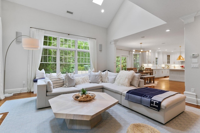 13 Witch Ln, Norwalk, CT 06853 - living room with light wood-style flooring, lofted ceiling, recessed lighting, and baseboards