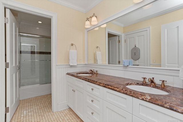 13 Witch Ln, Norwalk, CT 06853 - full bath featuring tile patterned floors, ornamental molding, double vanity, combined bath / shower with glass door, and a wainscoted wall