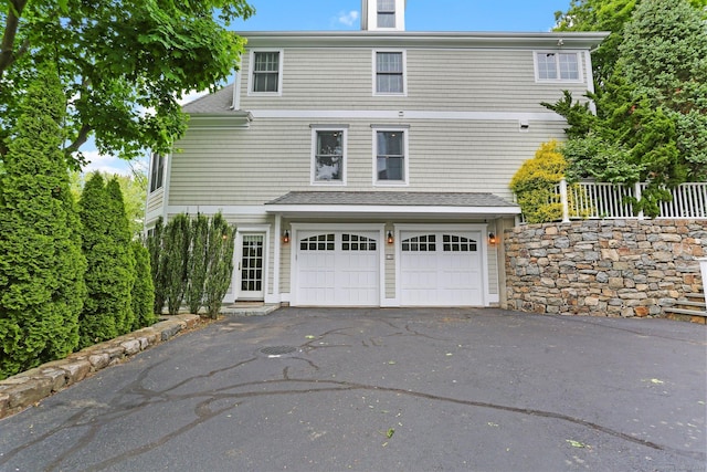 13 Witch Ln, Norwalk, CT 06853 - view of home's exterior featuring asphalt driveway, an attached garage, and roof with shingles