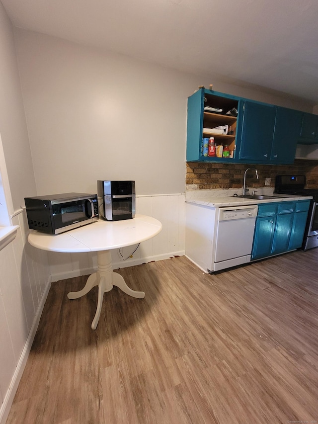 50 Greenhouse Rd Unit 41C, Bridgeport, CT 06606 - kitchen featuring stainless steel electric stove, white dishwasher, blue cabinetry, a sink, and a wainscoted wall