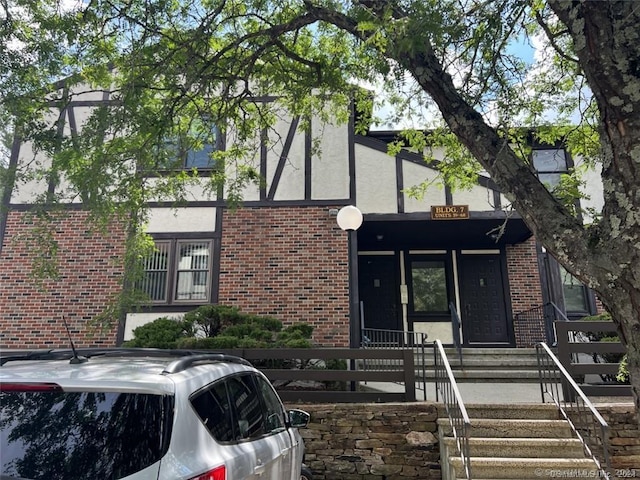 365 Mather St Apt 62, Hamden, CT 06514 - tudor-style house featuring stucco siding, brick siding, and a fenced front yard