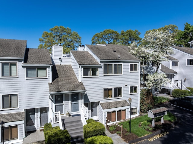 193 Rowayton Woods Dr Unit 193, Norwalk, CT 06854 - view of front of property featuring roof with shingles, a chimney, and a residential view