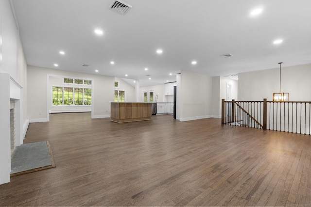 23 Aunt Pattys Ln W, Bethel, CT 06801 - unfurnished living room featuring dark wood-style floors, a chandelier, baseboards, a fireplace, and recessed lighting