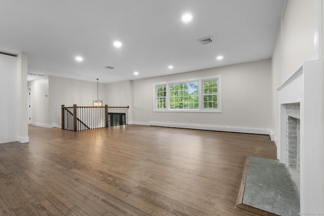 23 Aunt Pattys Ln W, Bethel, CT 06801 - unfurnished living room featuring a brick fireplace, wood finished floors, recessed lighting, a baseboard heating unit, and a chandelier
