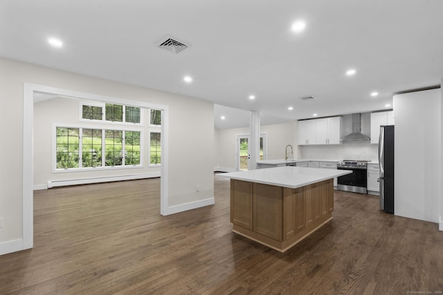 23 Aunt Pattys Ln W, Bethel, CT 06801 - kitchen featuring wall chimney exhaust hood, appliances with stainless steel finishes, a baseboard radiator, light countertops, and a center island