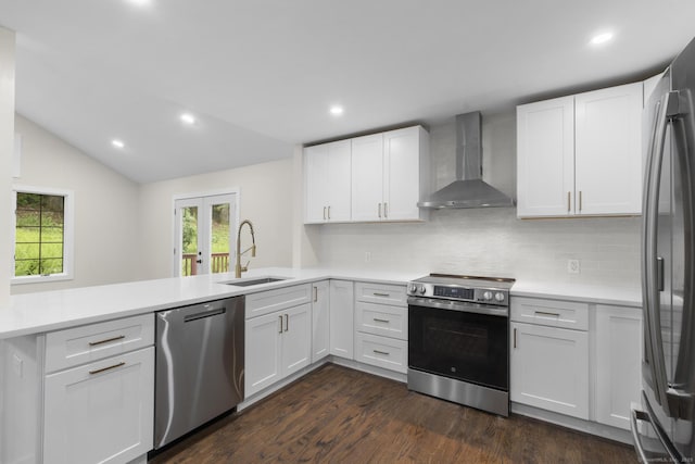 23 Aunt Pattys Ln W, Bethel, CT 06801 - kitchen featuring wall chimney exhaust hood, stainless steel appliances, a sink, a peninsula, and decorative backsplash