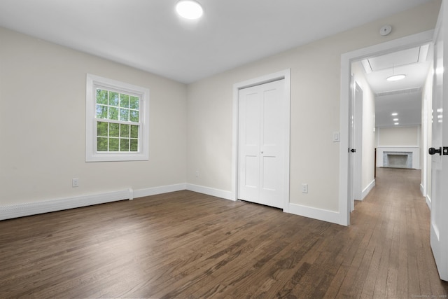 23 Aunt Pattys Ln W, Bethel, CT 06801 - unfurnished bedroom with dark wood-type flooring, attic access, baseboards, a baseboard radiator, and a closet