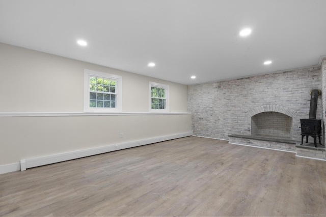 23 Aunt Pattys Ln W, Bethel, CT 06801 - unfurnished living room with wood finished floors, recessed lighting, a wood stove, baseboards, and baseboard heating