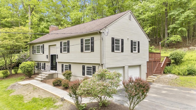 23 Aunt Pattys Ln W, Bethel, CT 06801 - bi-level home with asphalt driveway, a chimney, a garage, stairway, and roof with shingles