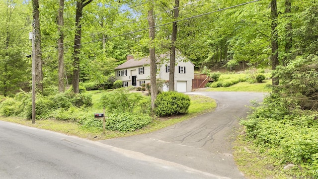 23 Aunt Pattys Ln W, Bethel, CT 06801 - view of front facade featuring a chimney, asphalt driveway, and a garage