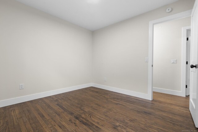 23 Aunt Pattys Ln W, Bethel, CT 06801 - empty room featuring baseboards, dark wood-type flooring, and a smoke detector