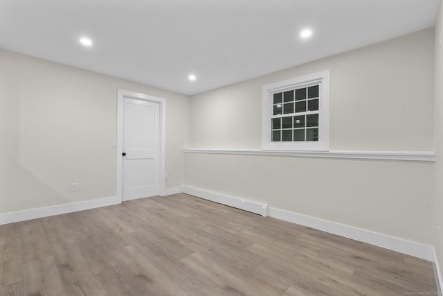 23 Aunt Pattys Ln W, Bethel, CT 06801 - spare room with wood finished floors, baseboards, a baseboard radiator, and recessed lighting
