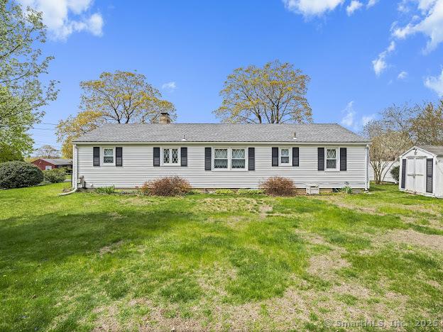 21 Poplar St, Enfield, CT 06082 - rear view of house with a lawn and a chimney