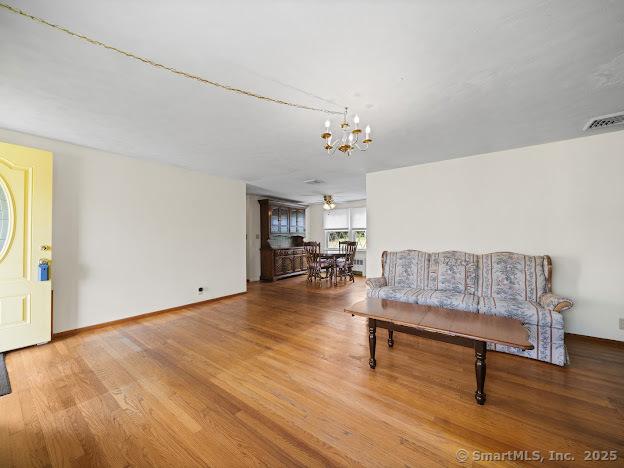 21 Poplar St, Enfield, CT 06082 - living area with a chandelier and wood finished floors