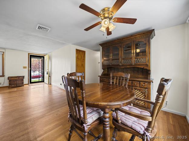 21 Poplar St, Enfield, CT 06082 - dining area featuring a ceiling fan, light wood finished floors, and baseboards