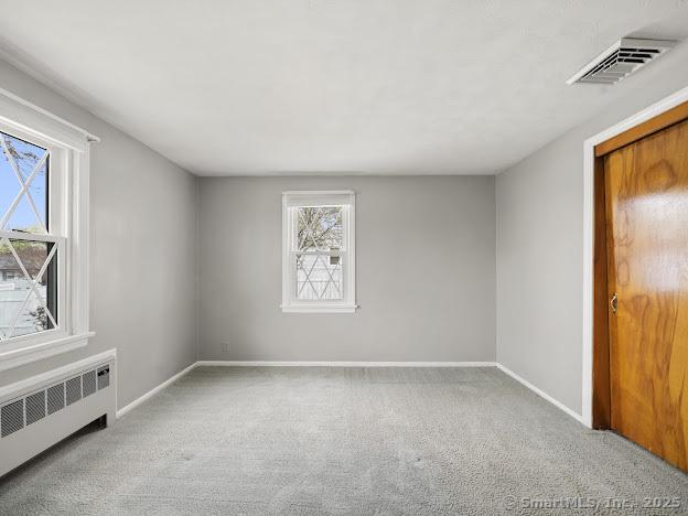 21 Poplar St, Enfield, CT 06082 - unfurnished bedroom featuring radiator heating unit, carpet floors, and baseboards