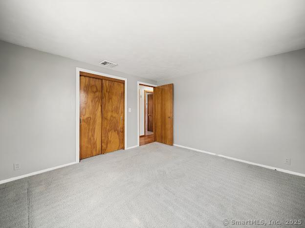 21 Poplar St, Enfield, CT 06082 - unfurnished bedroom with light colored carpet, a closet, and baseboards