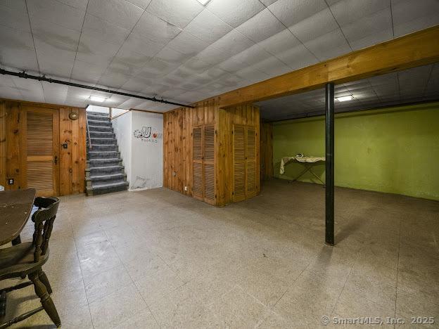 21 Poplar St, Enfield, CT 06082 - finished below grade area featuring stairs, wooden walls, and tile patterned floors