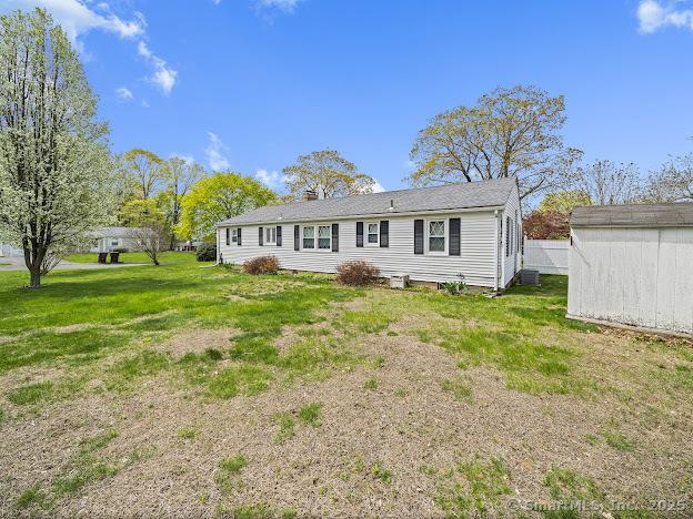 21 Poplar St, Enfield, CT 06082 - rear view of property with a yard and an outdoor structure