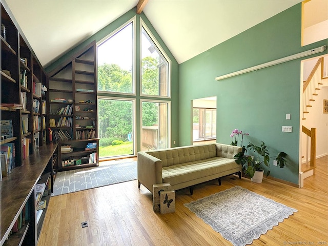 21 Holiday Point Rd, Sherman, CT 06784 - living area featuring high vaulted ceiling, wood finished floors, stairway, and beam ceiling
