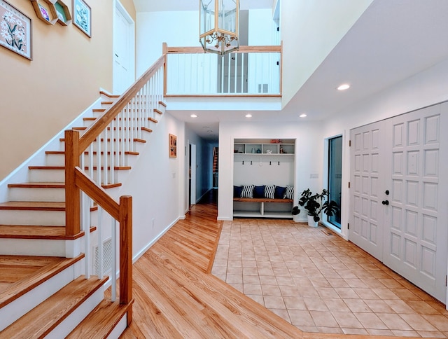 21 Holiday Point Rd, Sherman, CT 06784 - foyer entrance featuring stairs, a towering ceiling, a chandelier, wood finished floors, and recessed lighting