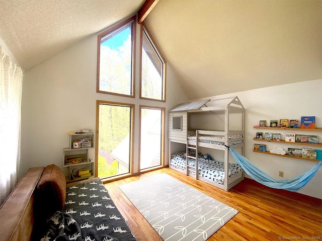 21 Holiday Point Rd, Sherman, CT 06784 - bedroom featuring wood finished floors, vaulted ceiling, and a textured ceiling