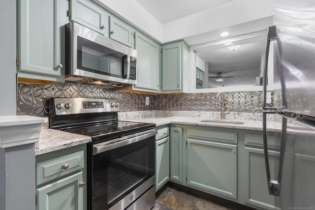 500 Darling St Unit 12M, Southington, CT 06489 - kitchen with stainless steel appliances, a sink, green cabinetry, and decorative backsplash