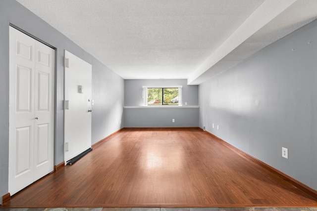 500 Darling St Unit 12M, Southington, CT 06489 - unfurnished room with wood finished floors, a textured ceiling, and baseboards