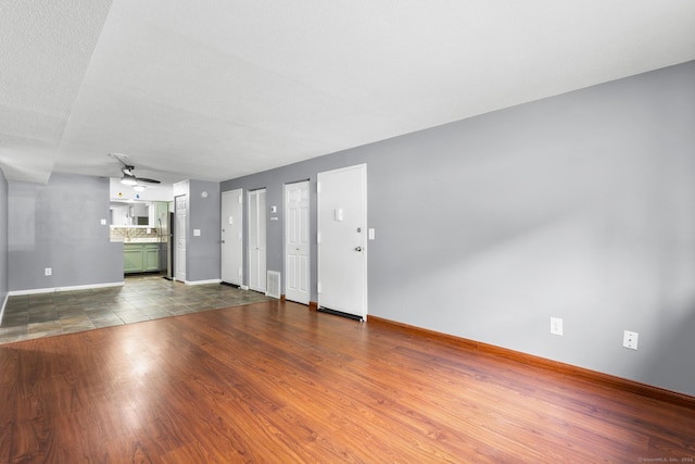 500 Darling St Unit 12M, Southington, CT 06489 - unfurnished living room featuring baseboards, ceiling fan, and dark wood-style flooring