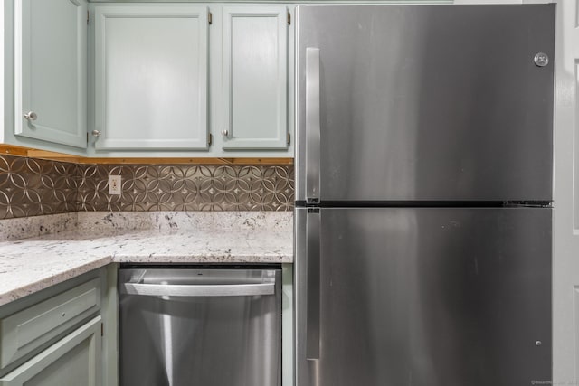 500 Darling St Unit 12M, Southington, CT 06489 - kitchen with appliances with stainless steel finishes, backsplash, and light stone countertops