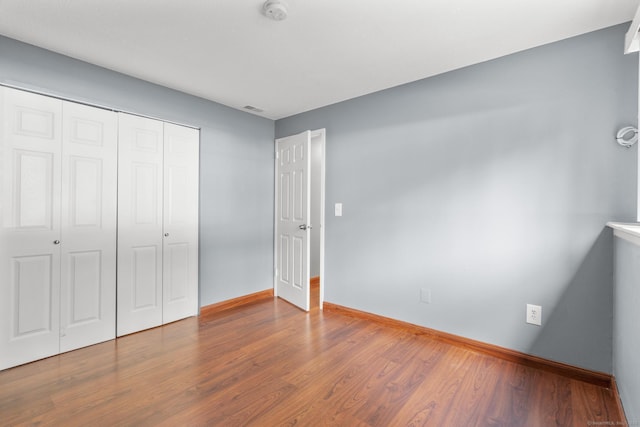 500 Darling St Unit 12M, Southington, CT 06489 - unfurnished bedroom featuring wood finished floors, baseboards, and a closet