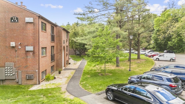 500 Darling St Unit 12M, Southington, CT 06489 - view of property featuring uncovered parking and view of wooded area