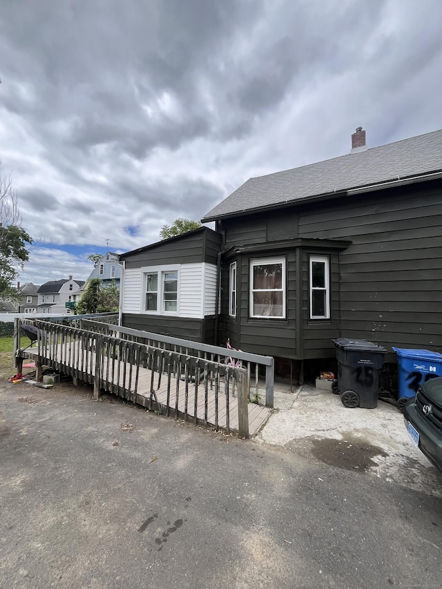 25 Bliss St, Hartford, CT 06114 - view of front of house featuring a wooden deck and a chimney