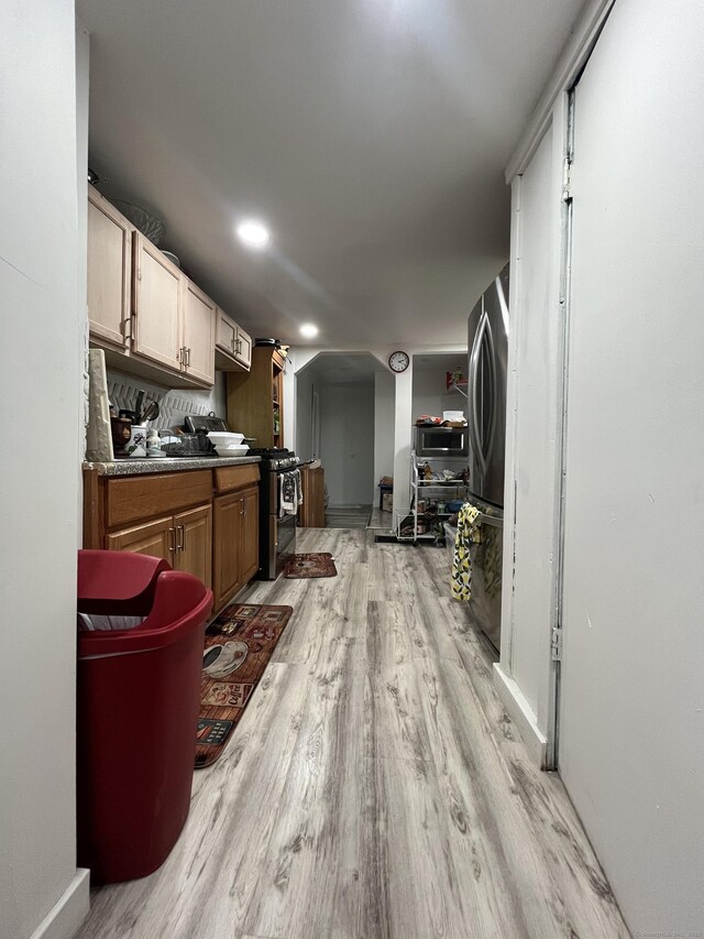 25 Bliss St, Hartford, CT 06114 - kitchen featuring light wood-style flooring, stainless steel appliances, dark countertops, recessed lighting, and baseboards