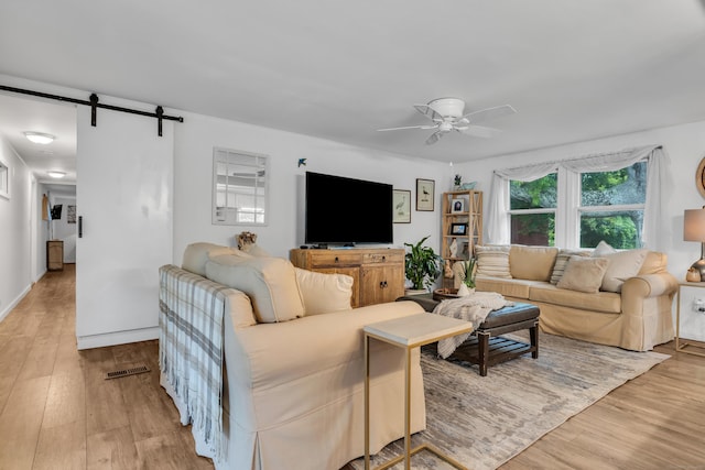 13 Green Acres Park Dr, Westbrook, CT 06498 - living room with ceiling fan, light wood-style floors, and a barn door