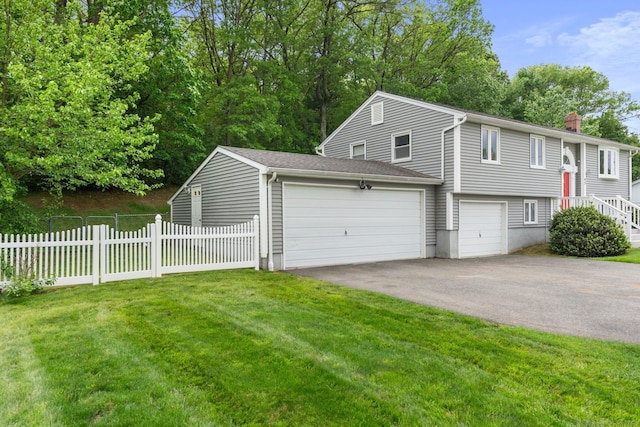 43 Worthington Rd, Glastonbury, CT 06033 - view of front of home with asphalt driveway, a chimney, and an attached garage