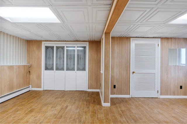 43 Worthington Rd, Glastonbury, CT 06033 - spare room featuring baseboard heating, wooden walls, an ornate ceiling, light wood finished floors, and baseboards
