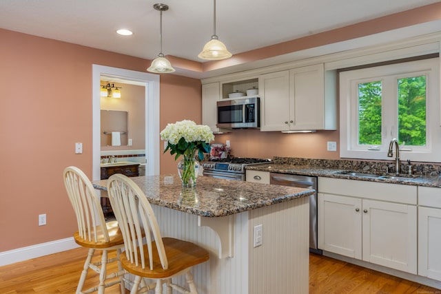 113 E Rd, East Windsor, CT 06016 - kitchen with stainless steel appliances, a sink, light wood-style floors, a breakfast bar, and recessed lighting