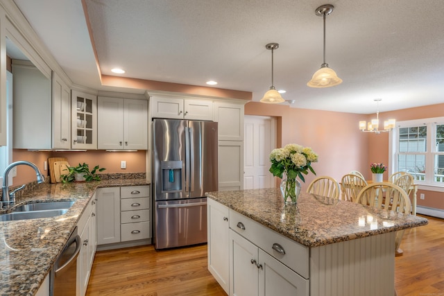 113 E Rd, East Windsor, CT 06016 - kitchen featuring appliances with stainless steel finishes, a sink, light wood-style flooring, a chandelier, and recessed lighting