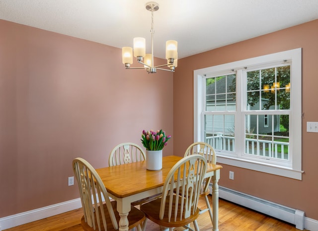 113 E Rd, East Windsor, CT 06016 - dining area with a baseboard heating unit, a chandelier, light wood-style flooring, and baseboards