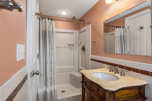 113 E Rd, East Windsor, CT 06016 - full bath featuring a shower with curtain, tile walls, a wainscoted wall, and vanity