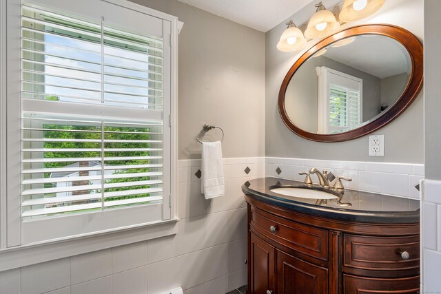 113 E Rd, East Windsor, CT 06016 - bathroom with vanity, plenty of natural light, tile walls, and a wainscoted wall