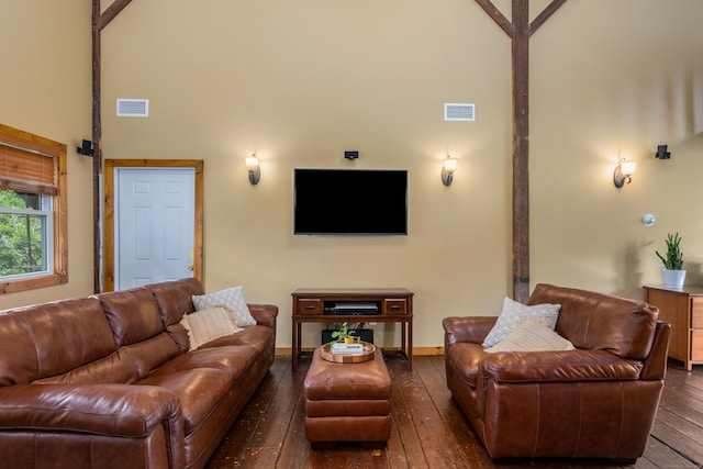113 E Rd, East Windsor, CT 06016 - living area with dark wood-style flooring, a towering ceiling, and baseboards