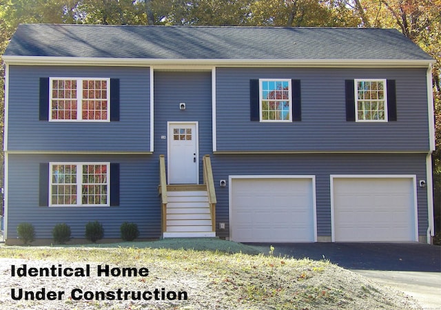 148 Gallup Hill Rd, Ledyard, CT 06339 - split foyer home featuring a garage and asphalt driveway
